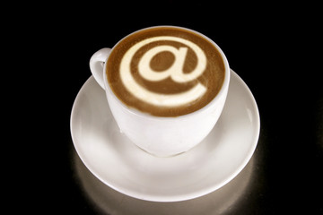 A cappucino with latte art at symbol