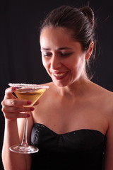 Beautiful young woman holding a martini glass