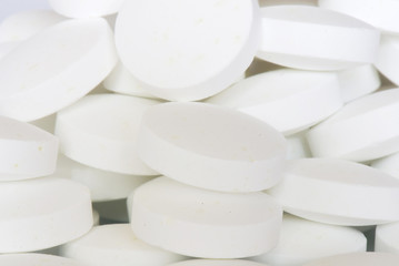 white round vitamins on the white isolated background