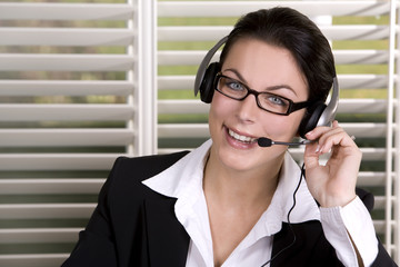 pretty business woman wearing headhset and the glasses