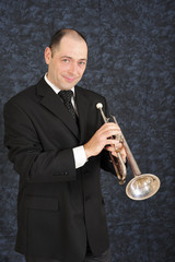 Professional trumpet player holding his trumpet..