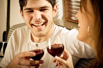 Happy young couple drinking wine