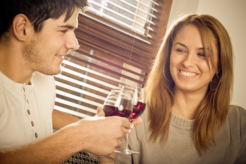 Happy young couple drinking wine