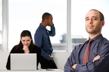 Obraz premium three business associates with a grey laptop