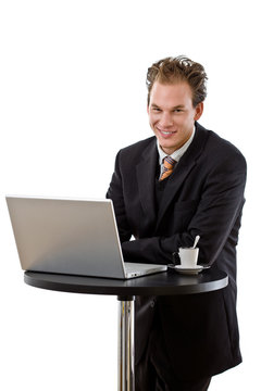 Businessman working on computer at coffee table,