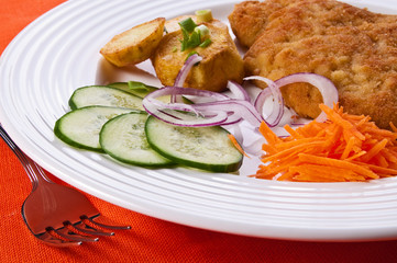 Fried chop pork with potatoes and vegetable salad