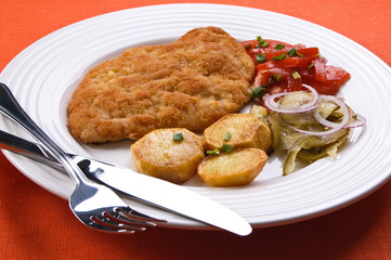 Fried chop pork with potatoes and vegetable salad