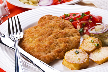 Fried chop pork with potatoes and vegetable salad