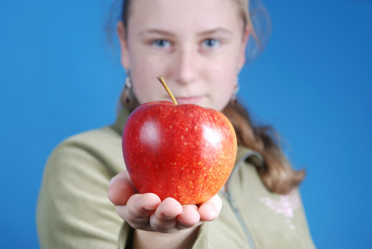 girl passing an apple