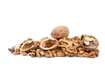 Fototapeta na wymiar Whole and cracked walnuts with nutshells over kernels