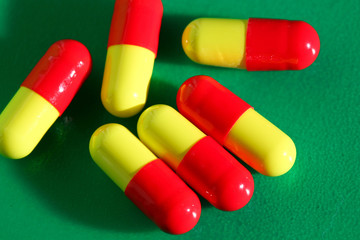 An image of pills on green background