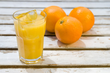 Glass of freshly squeezed orange juice with ice