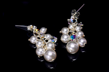 A pair of bead earrings isolated on black background.