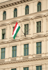 Fototapeta na wymiar Hungarian flag against office building facade.