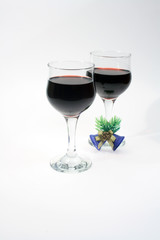 Two nice goblets of red wine with little jingle bells