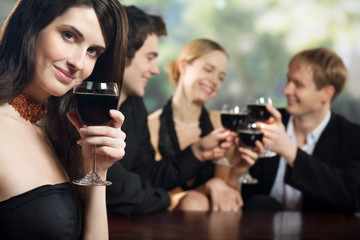 Two young couples with red wine at celebration or party