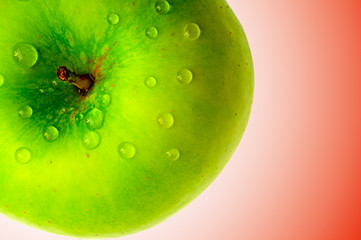 green apple on pink background in dewdrop