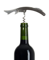 There is a wine bottle and corkscrew on it