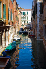 Fototapeta na wymiar A typical canal in Venice and a bridge