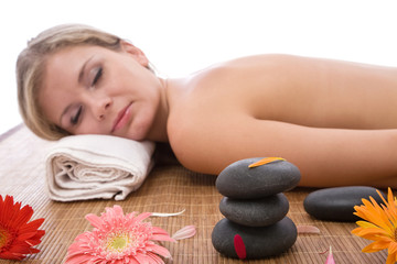 Obraz na płótnie Canvas lastone massage concept with a beautiful woman at the spa