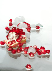 Berries of the broken pomegranate on glass