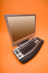 monitor and keyboard on the orange background
