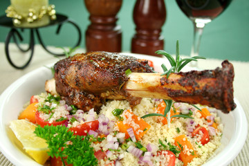 Lamb shank on tomato, pumpkin and parsley couscous.
