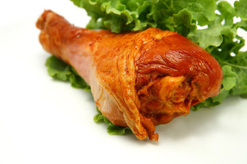 hot roasted chicken leg served with green lettuce