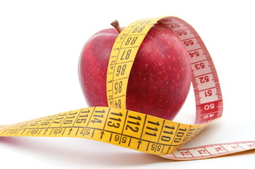 apple and measuring tape isolated on white background