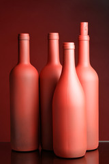 Still-life with four red wine bottles