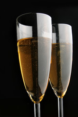 Two glasses of champagne close-uo over black background