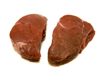 Two fillet mignon steaks on a white background