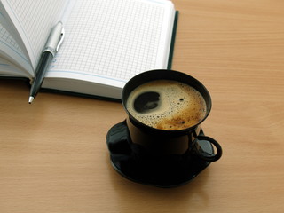 cup of coffe and notepad in office