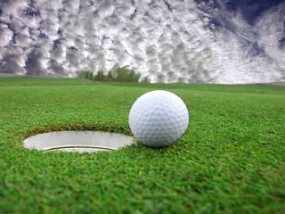 Golf - detail ball with hole on green