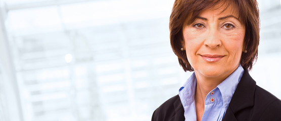 Portrait of senior businesswoman at office lobby.