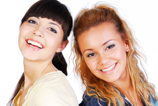 Portrait of two teen girlfriends on white background