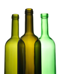 Three empty green wine bottles on white background.
