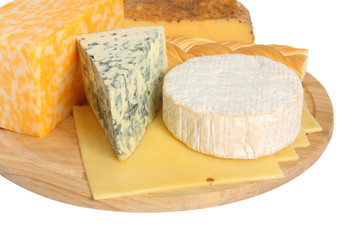 Various types of cheese on wooden platter