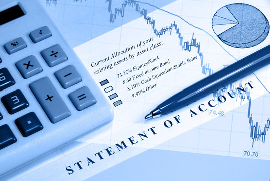 Asset statement, declining graph line, calculator, and pen