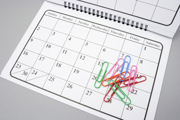 Calendar and Paper Clips on Grey Background