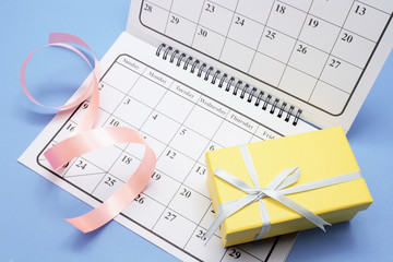 Gift Box and Calendar on Blue Background