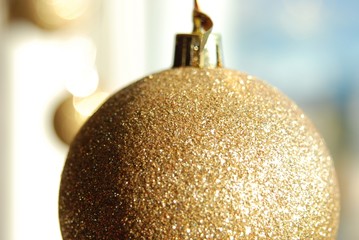 A golden ball hanging on a window
