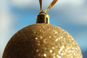 A golden ball hanging on a window