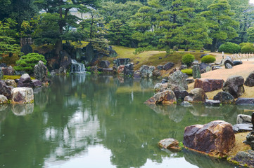 Fototapeta na wymiar Beautiful Japanese garden with trees and pond
