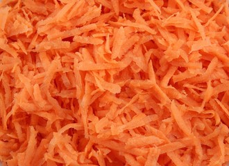 Fresh grated carrot background
