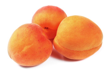 Three fresh peaches isolated on white background