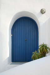Picturesque blue house door on Santorini Island, Greece.