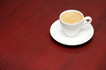 Coffee cup on a saucer, on table
