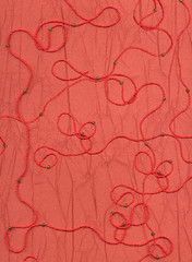 Red background with a pattern from a beads