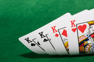 four kings on green felt